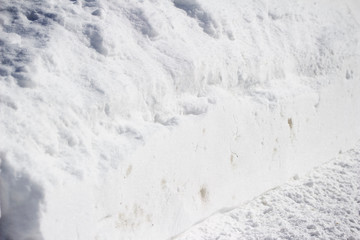 Fototapeta na wymiar Close-up view of a deep bank of shoveled snow