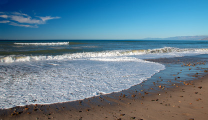 Seafoam wave patterns on Surfers Knoll beach in Ventura California United States