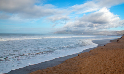 Seafoam wave patterns on Surfers Knoll beach in Ventura California United States