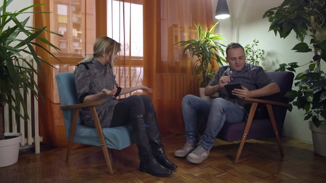 man and woman at home arguing and fighting about virtual reality goggles