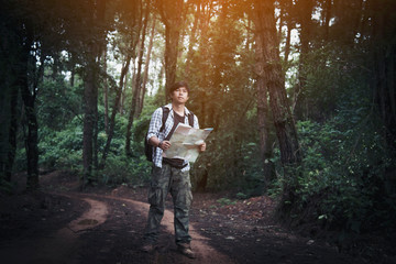 Young Man Traveler with backpack relaxing outdoor with rocky mountains on background Summer vacations and Lifestyle hiking concept