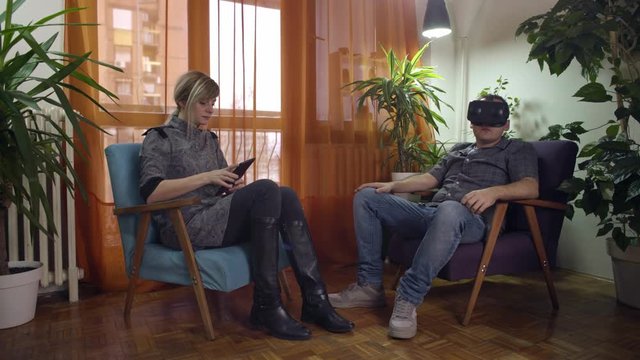 man and woman at home arguing and fighting about virtual reality goggles