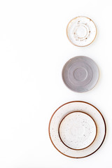 Ceramic plates pattern on white background top view copy space