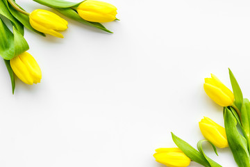 Spring composition. Bouquet yellow tulips on white background top view space for text