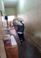 someone is carrying goods in a traditional market