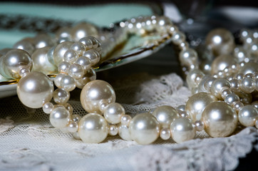 pearl necklace on blue background