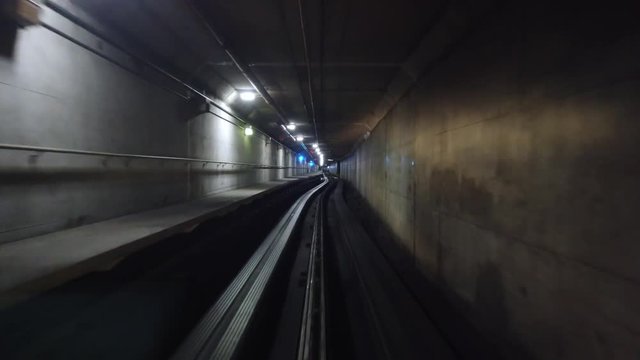 A forward perspective of a passenger's view riding in an underground subway or train.  	