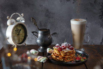 tasty belgian waffles with sugar powder and latte