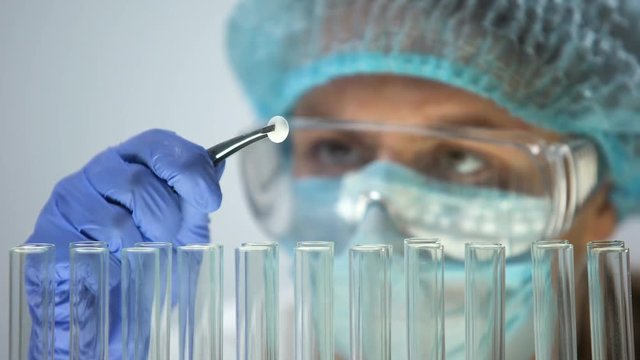 Researcher holding tablet, conducting medication quality control, effectiveness