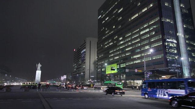 WS Traffic on downtown street at night with Yi sun-sin statue / Seoul, South Korea