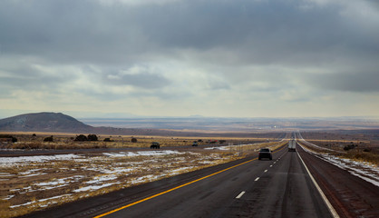 A highway runs from Tucumcari, New Mexico through the brush and mesas of the high desert.