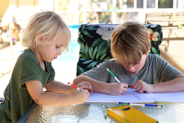 Two Little Kids Drawing on Paper Outside by Pool on Summer Day