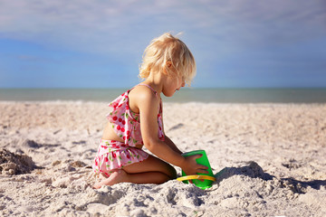 Little Toddler Kid Playing at Beach Building a Sand Castle
