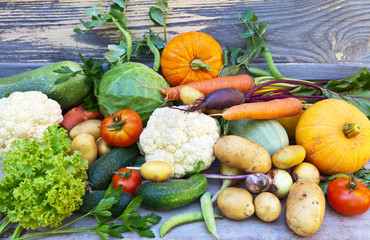 Freshly picked raw vitamin vegetables on a wooden background. Rustic still life. Useful bio products. Healthy food