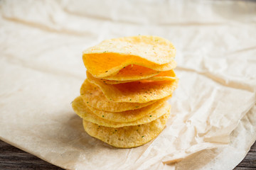 Salty chips on the rustic background. Selective focus. Shallow depth of field.