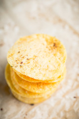 Salty chips on the rustic background. Selective focus. Shallow depth of field.