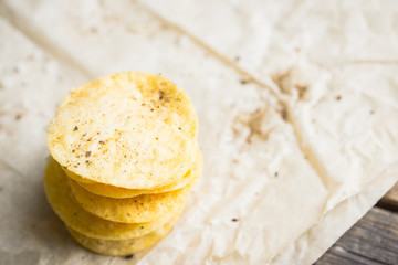 Salty chips on the rustic background. Selective focus. Shallow depth of field.