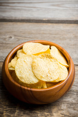 Salty chips on the rustic background. Selective focus. Shallow depth of field.