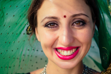 portrait of a beautiful and smiling snow-white smile indian woman black curly hair and dark skin in...