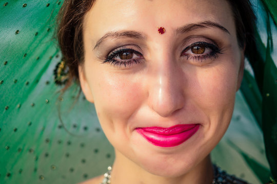 portrait of attractive indian female model in vacation on paradise tropical beach ocean sea. hindu woman with kundan jewelry set traditional India costume sari.asian girl sensual look bindi tikka
