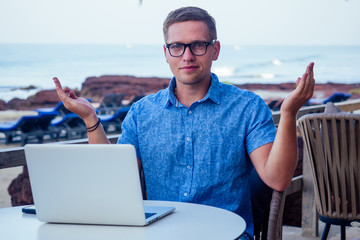 handsome and successful man in a stylish well-dressed freelancer working laptop meditating in the...