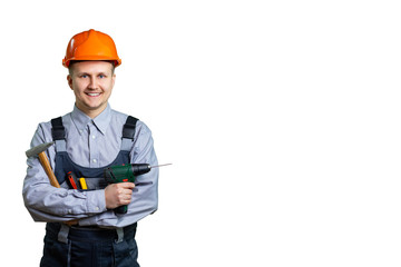 Engineer builder in helmet and tools in hand, ready for repair or construction of buildings. A handsome young worker greets you. isolated