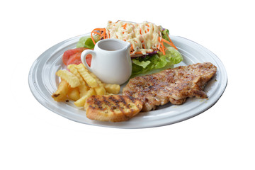 Chicken steak, french fries, garlic bread, salad and gravy sauce on white plate isolated.