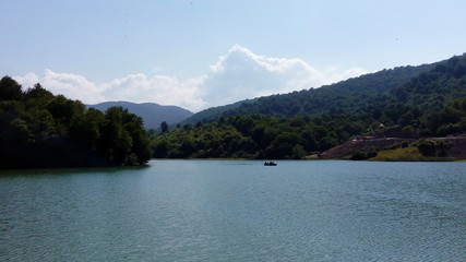 Beautiful landscape image. Lake, forest, trees and mountains. Lake and Sky View Lakeside in the mountains.