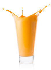 Glass of citrus or carrot smoothie or yogurt with splash