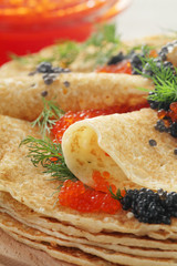 Russian pancakes with red and black caviar