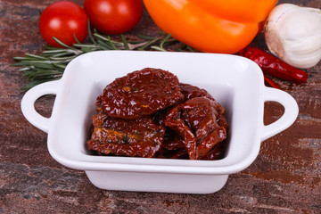 Dried tomatoes in the bowl with olive oil