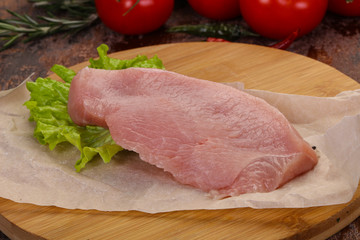 Raw Turkey steak served rosemary