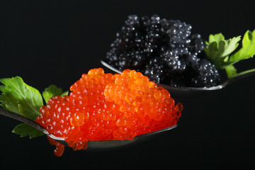 Two spoons with red and black caviar