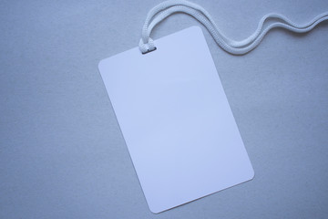 Badge blank plastic empty security. Name id card badge with cord on grey background, empty space for text.