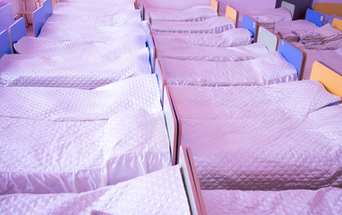 Cots in the kindergarten. orphanage or boarding school. beds in a boarding school or in an orphanage