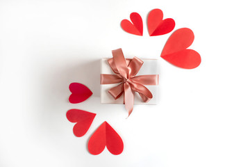 Box with a gift on the background of red hearts White isolated background