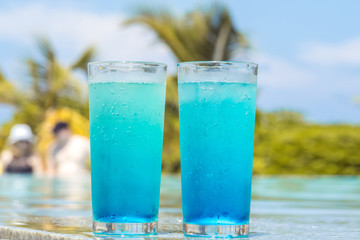 Two glasses with a bright blue drink on the table on the hotel terrace.