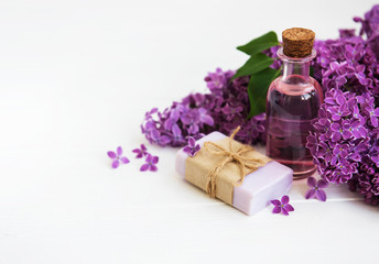 Fototapeta na wymiar Essential oil with lilac flowers