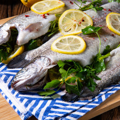 fresh trout with lemon and different herbs