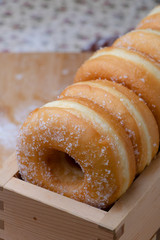 Donuts are arranging in the wooden box