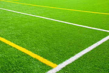 Fototapeta premium Football field green background with white and yellow line. Sport texture.