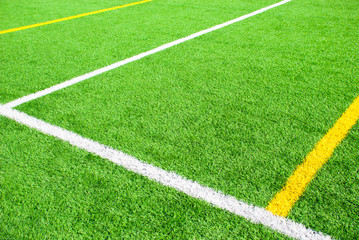 Obraz premium Football field green background with white and yellow line. Sport texture.