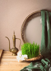 Novruz still life with semeni sabzi wheatgrass , silk national scarf, eastern musical instrument and orchids. Spring equinox in March celebration, copy space 