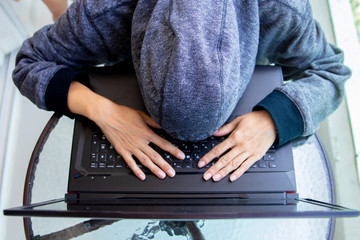 Woman Hacker programmer is working on computer in cyber security center filled with display screens.