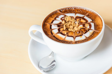 Add sugar to hot coffee on table