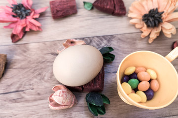 Easter, preparation for Easter, still life, story for Easter, eggs, colored objects, flowers, wooden background, wreath,