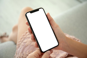 female hands in pink dress holding phone with isolated screen