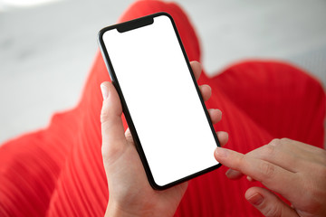 female hands in red dress holding phone with an isolated screen