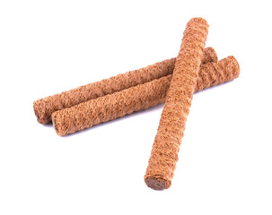 Waffle rolls with chocolate cream on white background