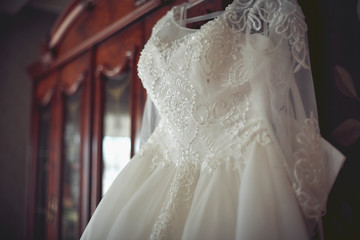Fototapeta na wymiar bride's morning. wedding dress hanging.